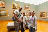 Members of a school group looking at art while at the Getty Center.